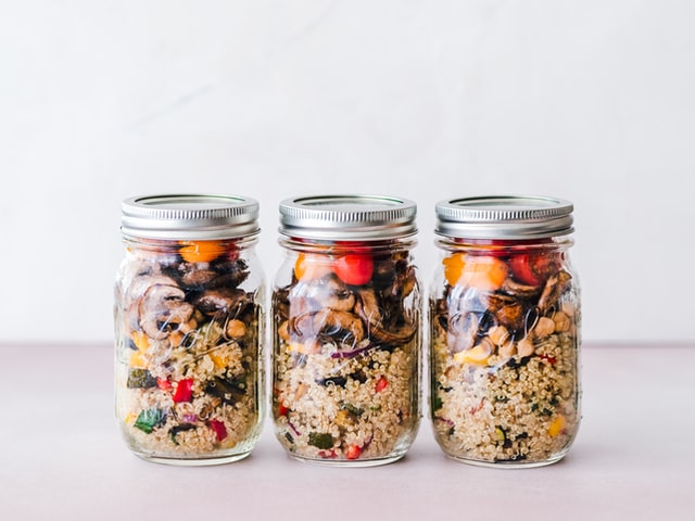 3 mason jars full of quinoa and salad
