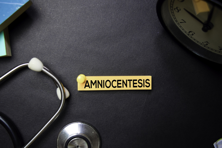Amniocentesis text on sticky notes on black background