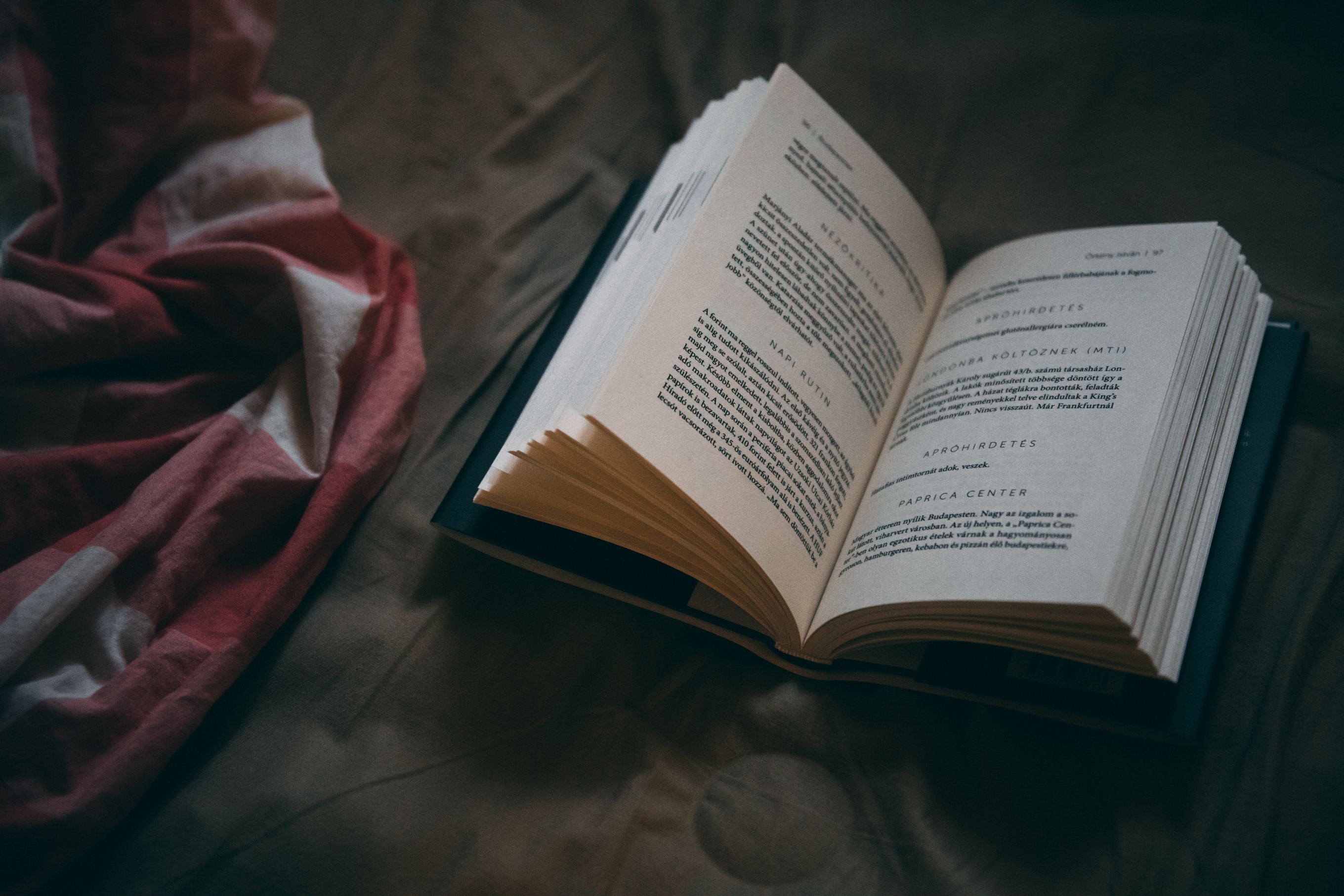 An open book on a bed