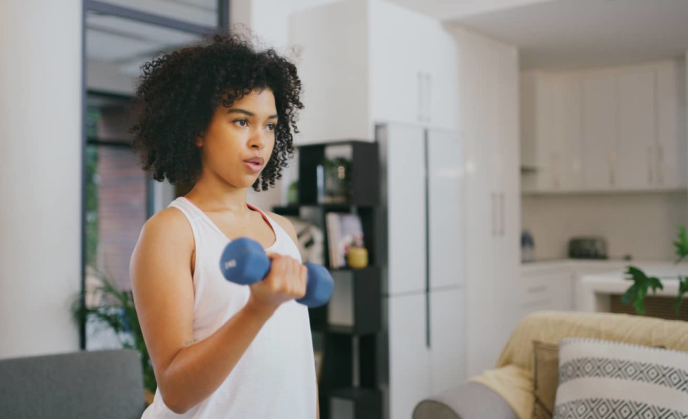 Person doing arm exercises with weights bicep curls