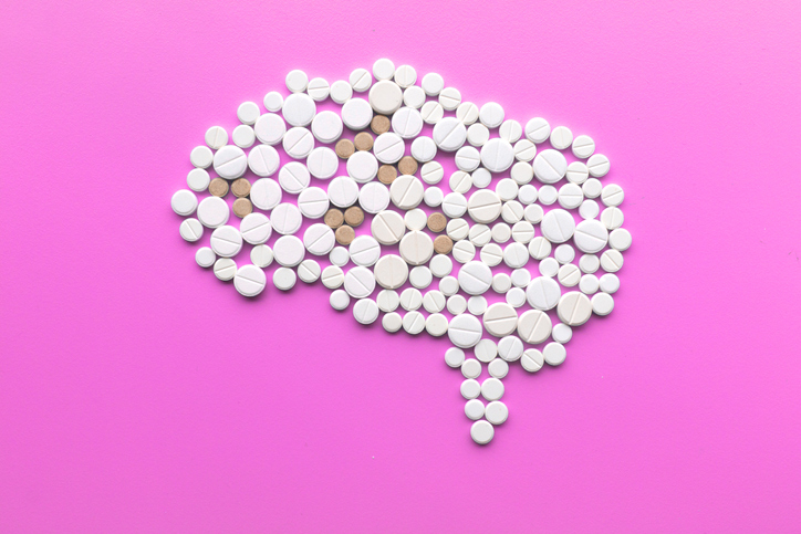 Brain made of pills on pink background, multiple sclerosis day concept