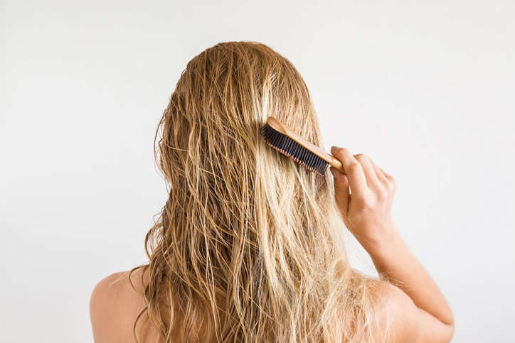 Person brushing their hair after a shower