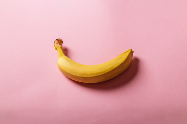 A banana on a pink background