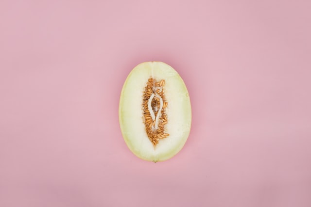 Half a melon on a pink background 