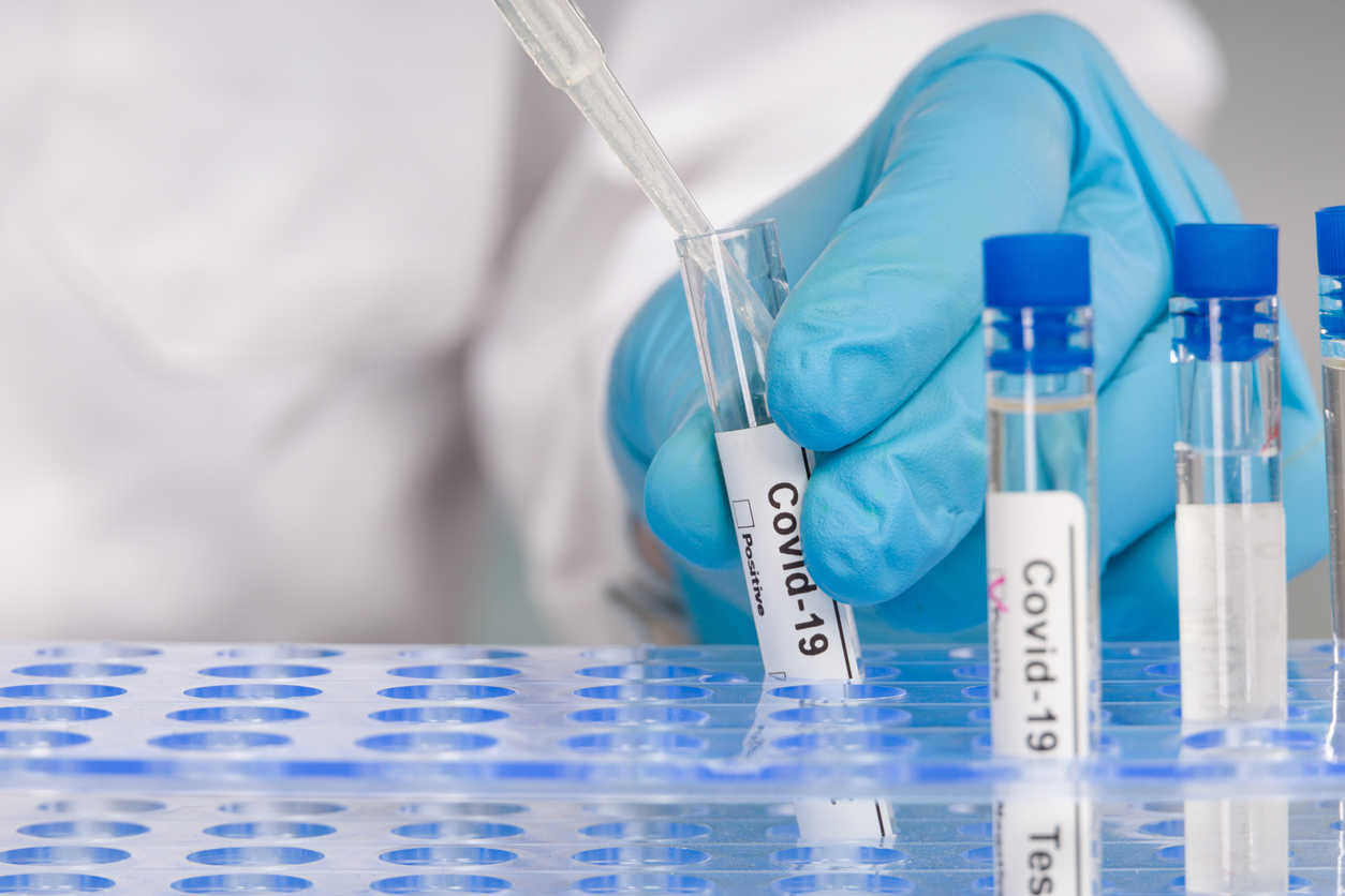 doctors-hand-with-glove-using-test-tube