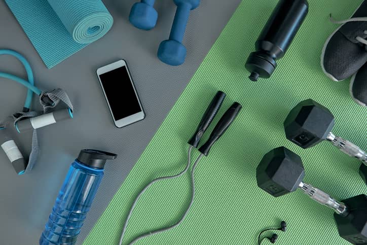 Exercise equipment on green and grey workout mats