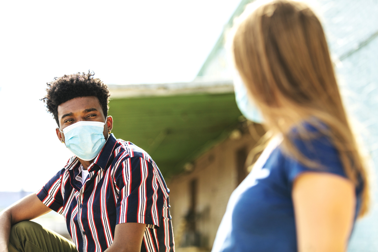 Two people wearing masks on a date