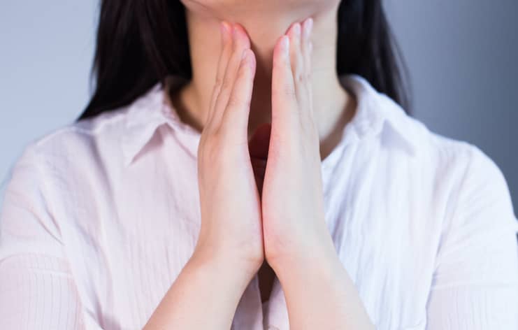 Woman holding her neck
