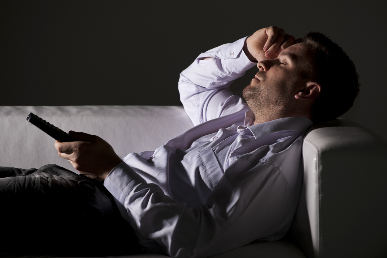man-on-sofa-looking-tired