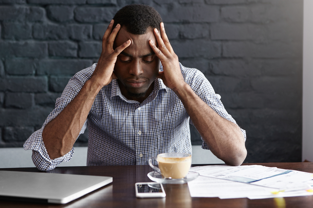 man-with-bad-headache-holding-his-head