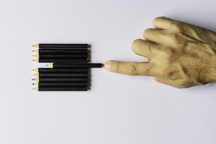 Obsessive compulsive disorder, male hand obsessively ordering some coloured pencils