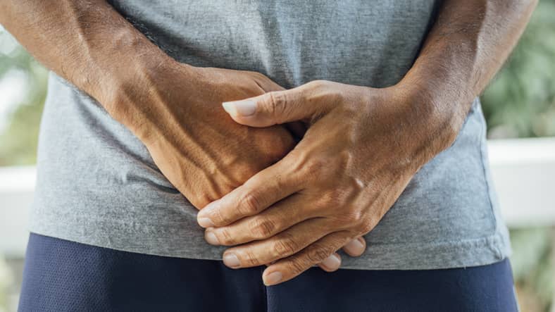 Person holding their genitals