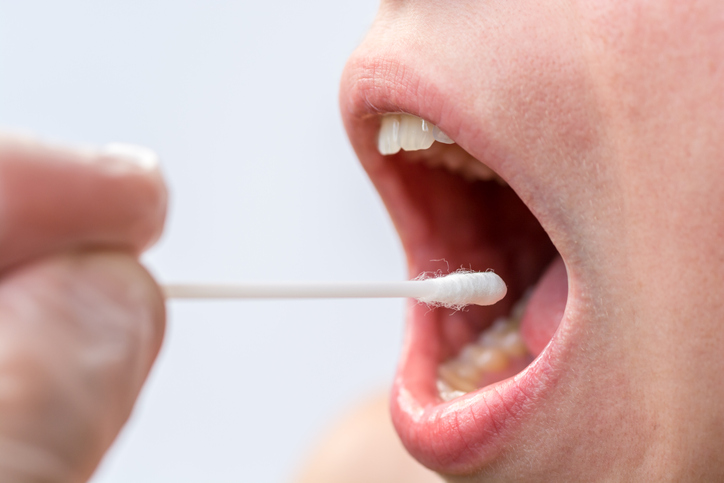 Taking a saliva sample with a cotton bud