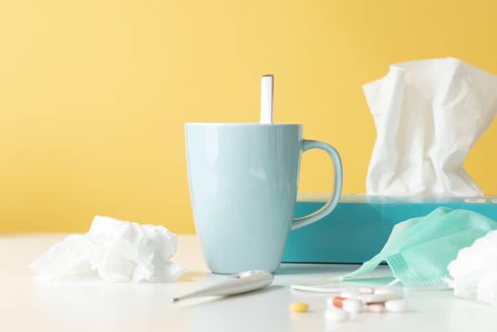 Box of tissues, thermometer, tea and other cold treatments