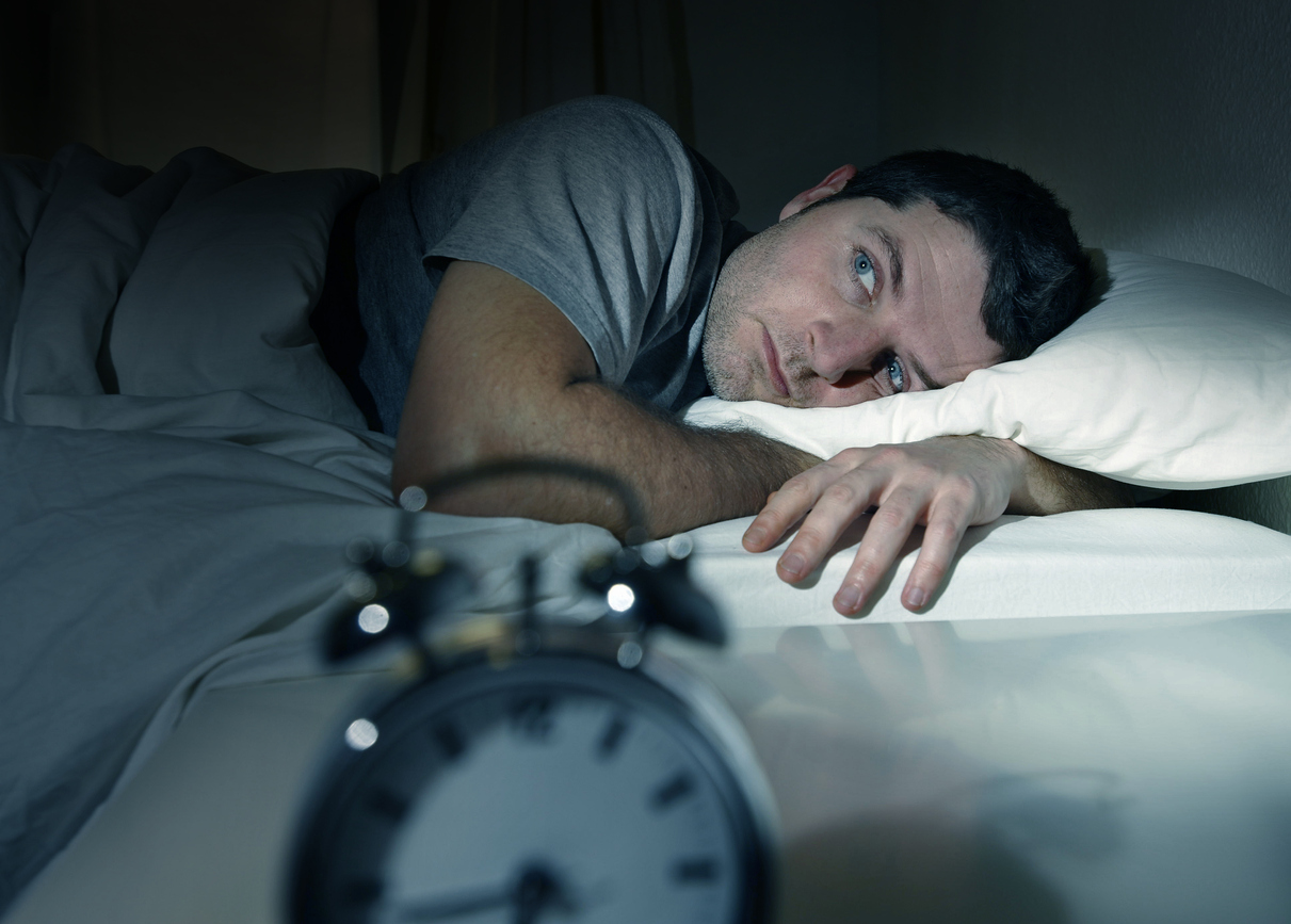 man-awake-in-bed-at-night