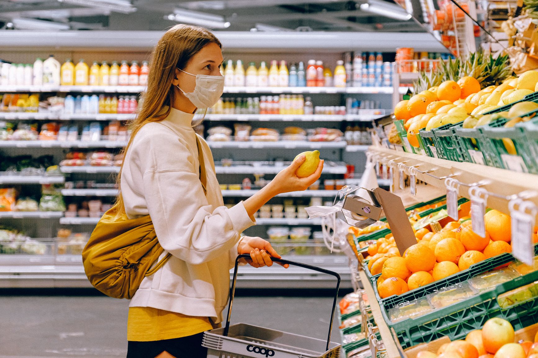  Woman shopping in a supermarket wearing a face mask