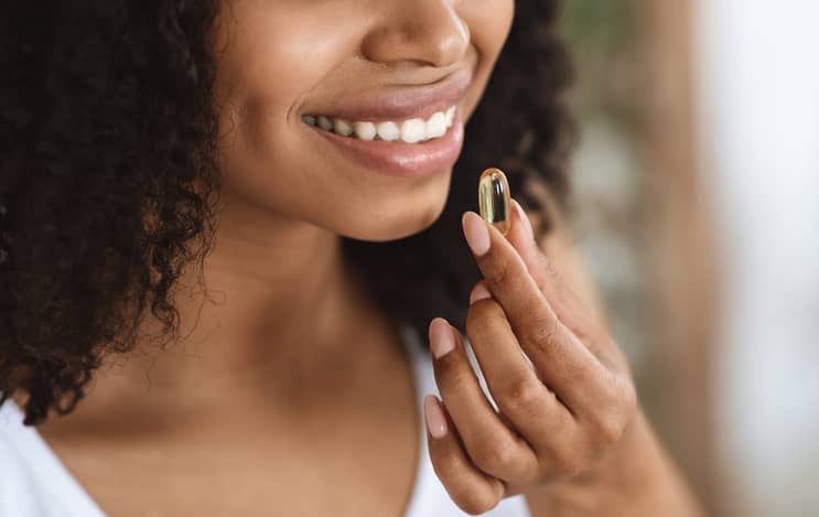 Woman taking a fertility supplement