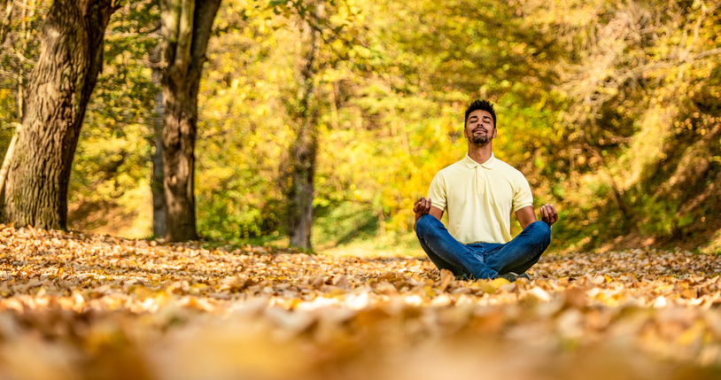 Young man taking a break in nature and meditating