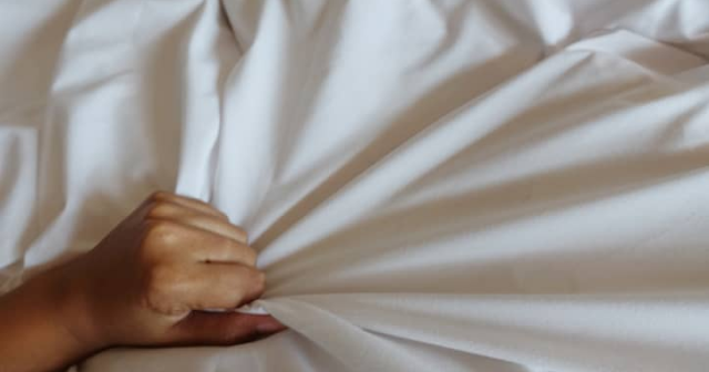 Hand of women pulling white sheets